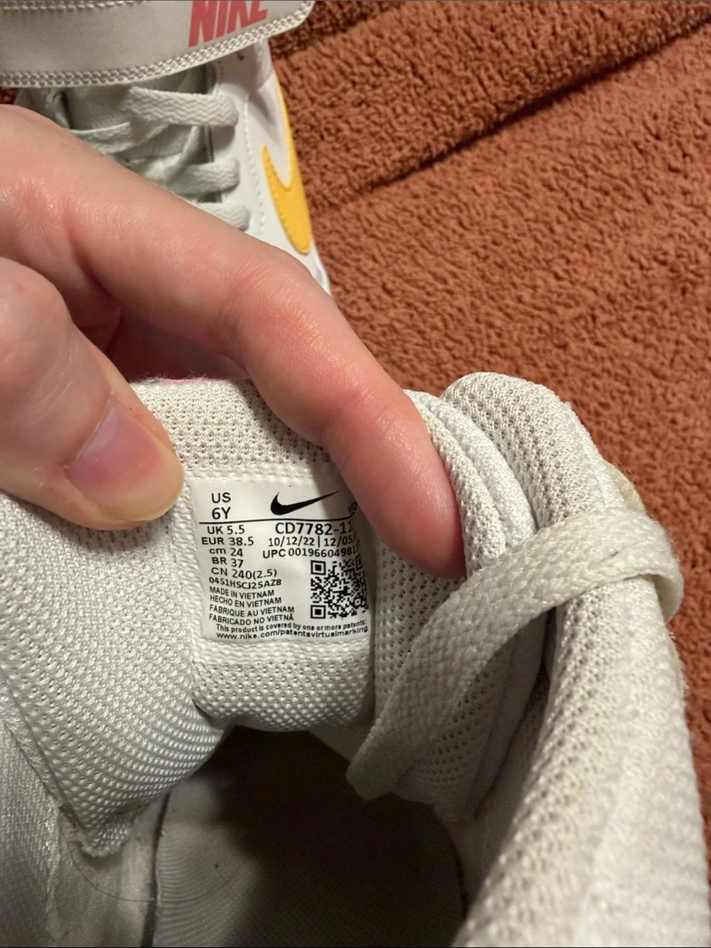 Nike White Mid-Top Sneakers with Yellow Swoosh
